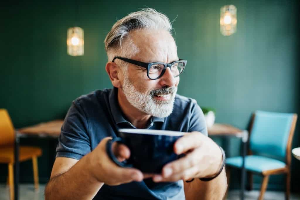 Man Holding a Cup